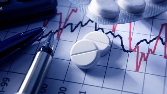 Painkillers on Stock Chart stock photo