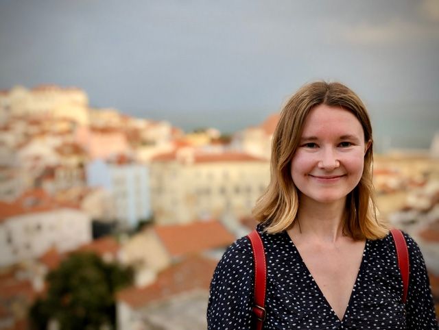Dr. Emma Banks. Credit: Samuel Lockett. Head shot of Dr. Emma Banks with buildings in the background.
