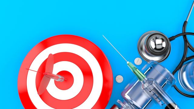 Therapeutic drugs next to a stethoscope and target with a dart in the bullseye.