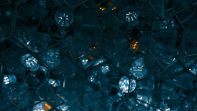 White lights reflected in hexagonal cages.