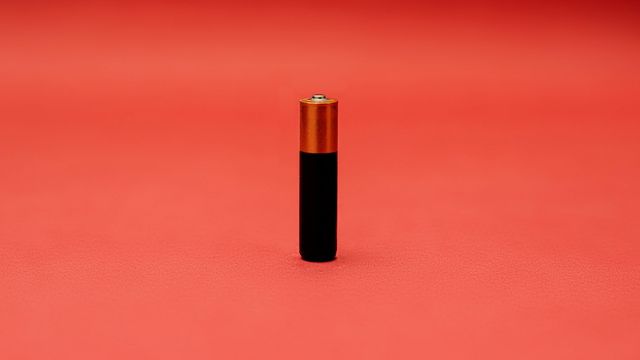 A black and gold battery stands on one end.