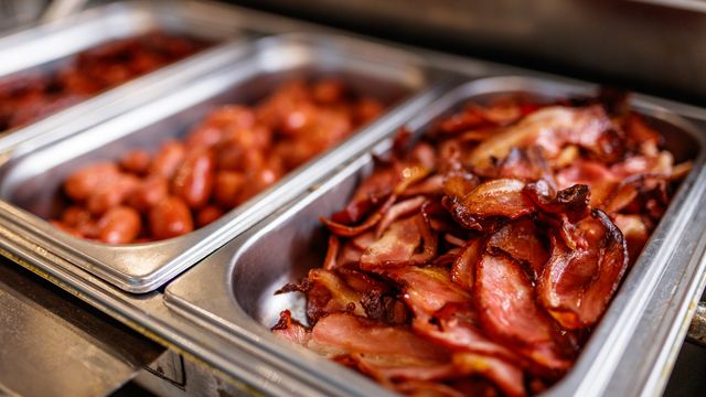 A steel tray of bacon.